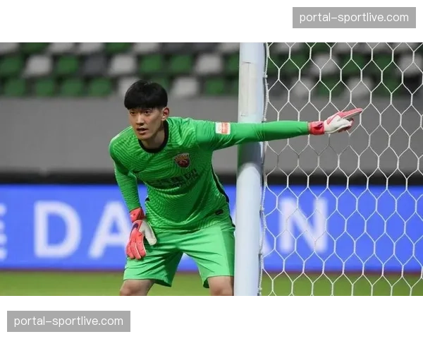 特写:门将颜骏凌扑出关键点球后,与后卫拥抱庆祝